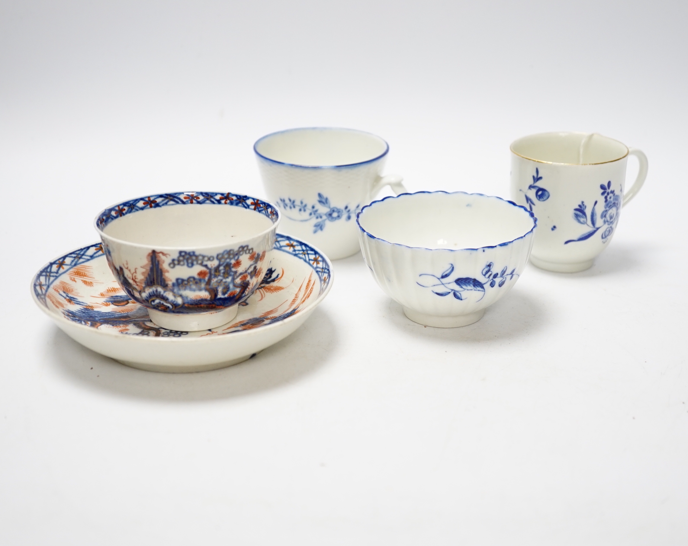 A Worcester James Giles decorated coffee cup, c.1765-70, a Caughley reeded tea bowl, a Pennington tea bowl and saucer and a coffee cup, tallest cup 6.5cm (4)